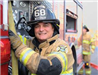 Smiling fireman beside side of truck