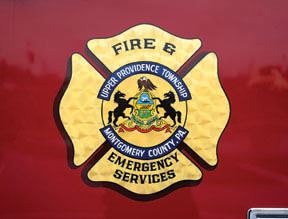 Fire and emergency services badge up close on side of truck